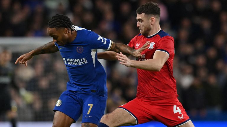 Raheem Sterling fights for the ball with Ben Whiteman