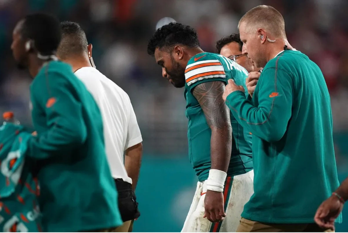 Sep 12, 2024; Miami Gardens, Florida, USA; Miami Dolphins quarterback Tua Tagovailoa (1) walks off the field with training staff after an apparent injury during the second half against the Buffalo Bills at Hard Rock Stadium. Mandatory Credit: Jasen Vinlove-Imagn Images