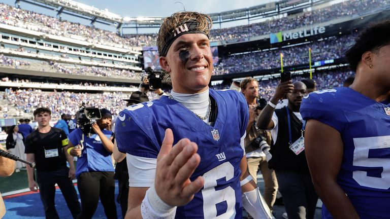 New York Giants quarterback Jaxson Dart (6) greets players on the field after defeating the Los Angeles Chargers in an NFL football game, Sunday, Sept. 28, 2025, in East Rutherford, N.J. (AP Photo/Adam Hunger)