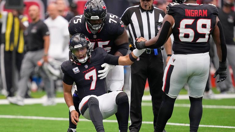 Houston Texans quarterback C.J. Stroud (7) is helped to his feet by guards Laken Tomlinson (75) and Ed Ingram (69) during the first half of an NFL football game against the Tennessee Titans, Sunday, Sept. 28, 2025, in Houston. (AP Photo/David J. Phillip)
