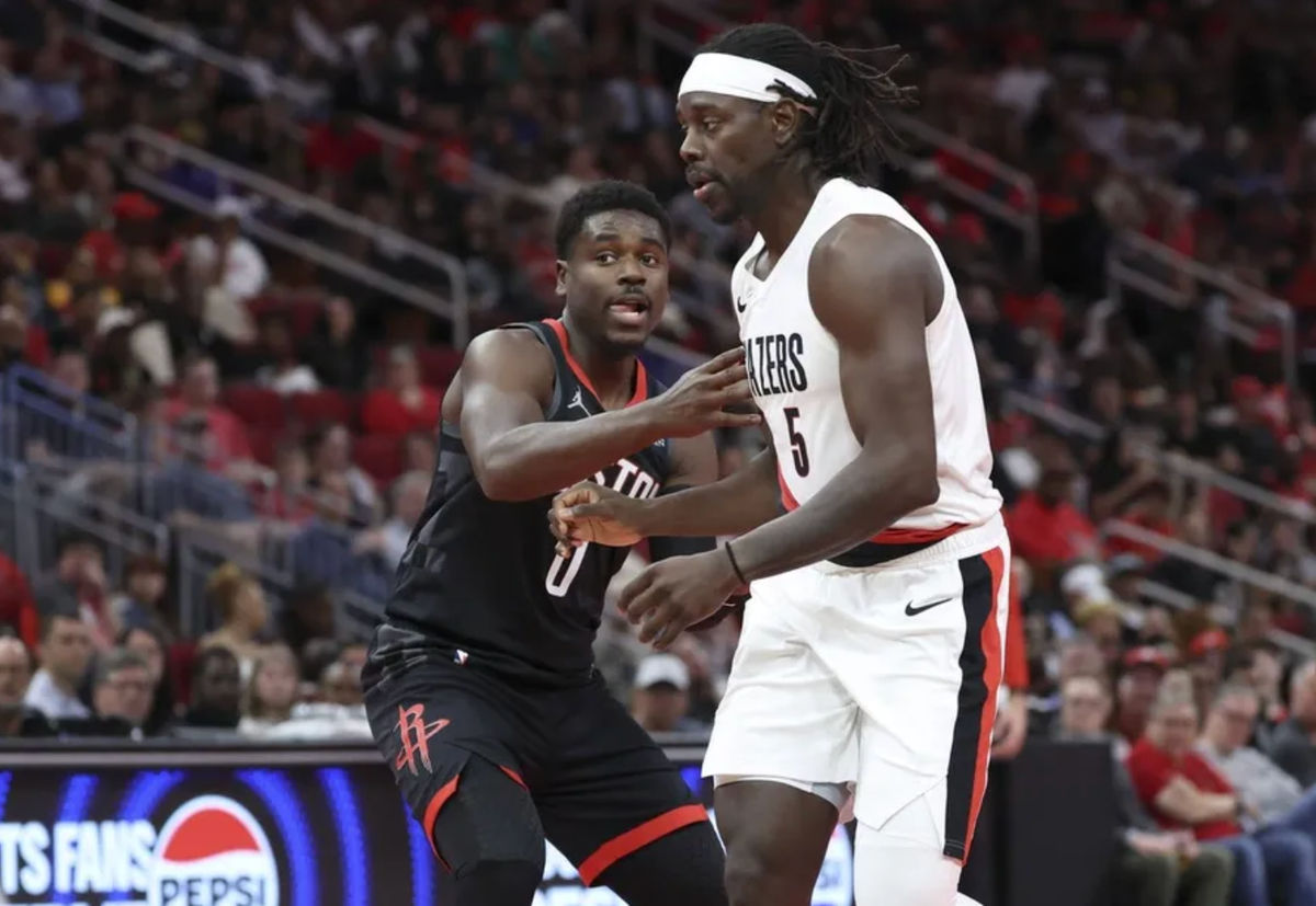 Nov 14, 2025; Houston, Texas, USA; Houston Rockets guard Aaron Holiday (0) defends against Portland Trail Blazers guard Jrue Holiday (5) during the third quarter at Toyota Center. Mandatory Credit: Troy Taormina-Imagn Images